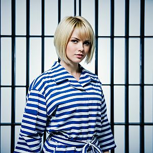 Blonde Woman in Blue and White Striped Outfit with Graphic Background