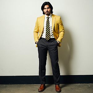 Confident Man in Yellow Blazer Against White Wall