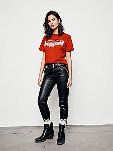 Woman in Red Graphic T-Shirt and Black Leather Pants with Lace Cuffs
