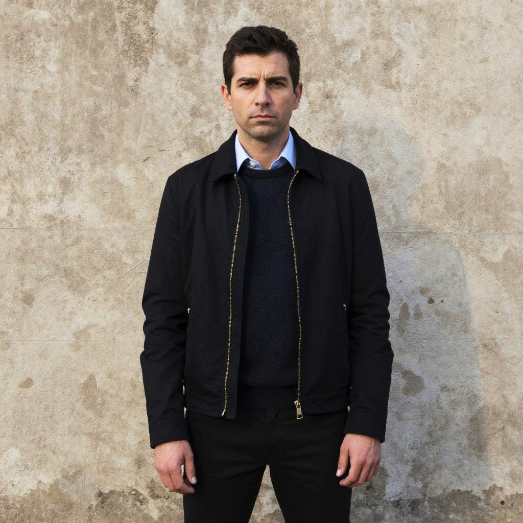 Portrait of Young Man in Casual Jacket Standing Against Stone Wall