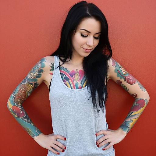 Confident Woman with Full Sleeve Traditional Tattoos Against Red Wall