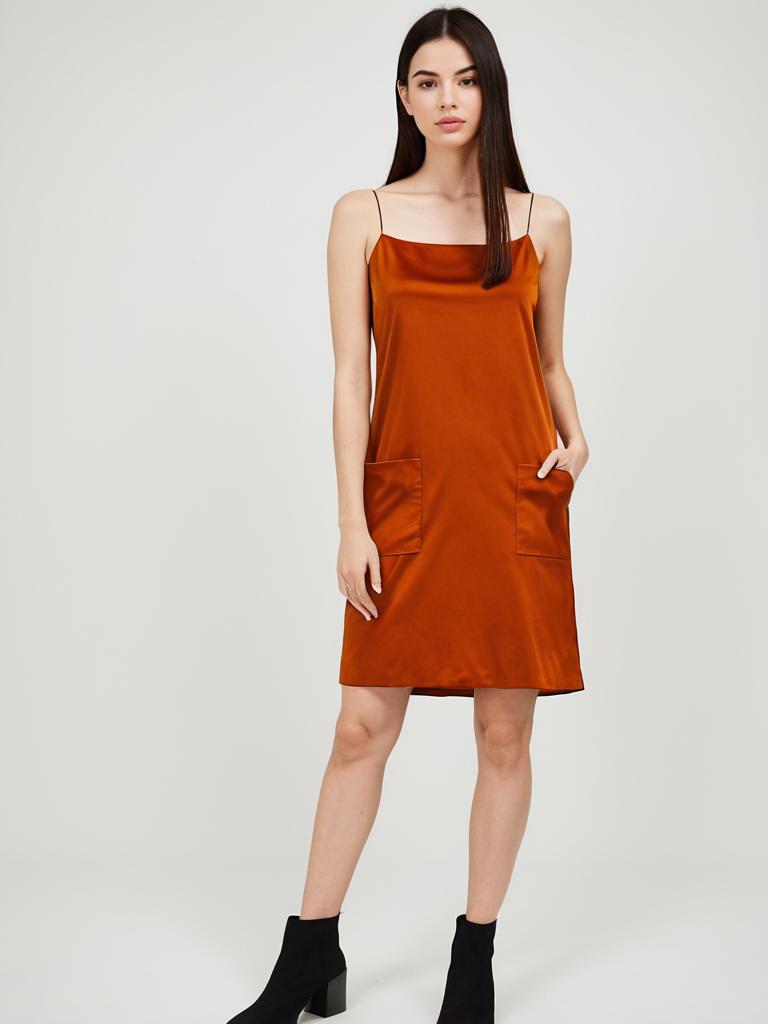 Woman in Minimalist Burnt Orange Spaghetti Strap Slip Dress with Pockets