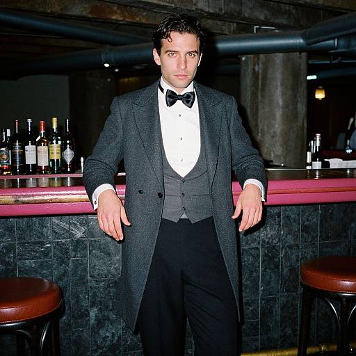 Man in Classic Formal Attire Leaning at Bar in Vintage Setting