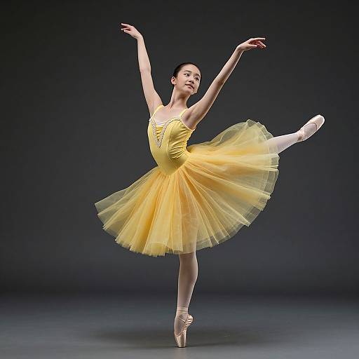 Photograph of a graceful ballerina in a yellow tutu, performing an elegant arabesque on pointe, with arms raised against a dark