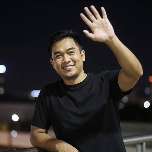 Smiling Asian Man Waving at Night