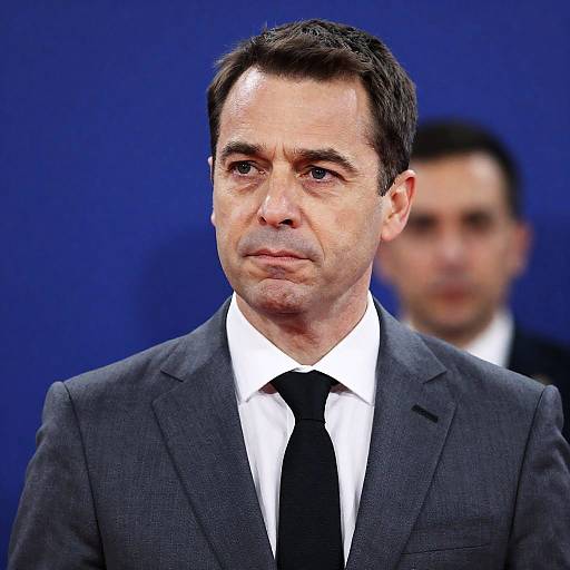 Focused Middle-Aged Man in Gray Suit