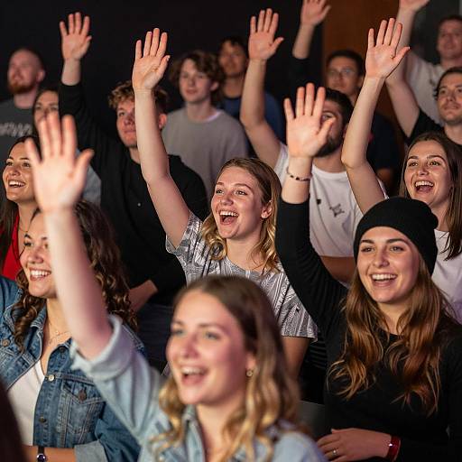 Vibrant Crowd Cheering in Dim Venue