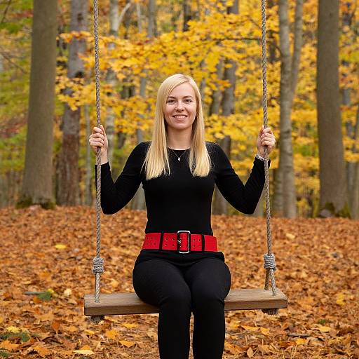 Smiling Blonde Woman on Autumn Swing
