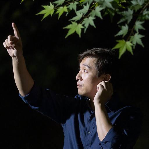 Man in Dark Blue Shirt, Pointing Upward