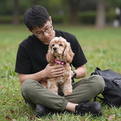 Young Man with Cocker Spaniel in Park