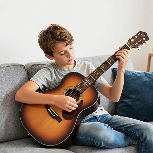 Young Boy Relaxing with Acoustic Guitar