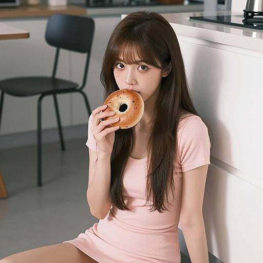 Asian Woman Enjoying a Toasted Bagel