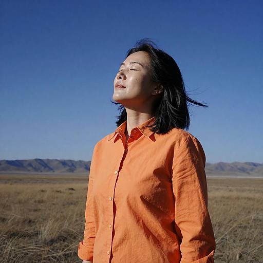 Serene Asian Woman in Orange Shirt