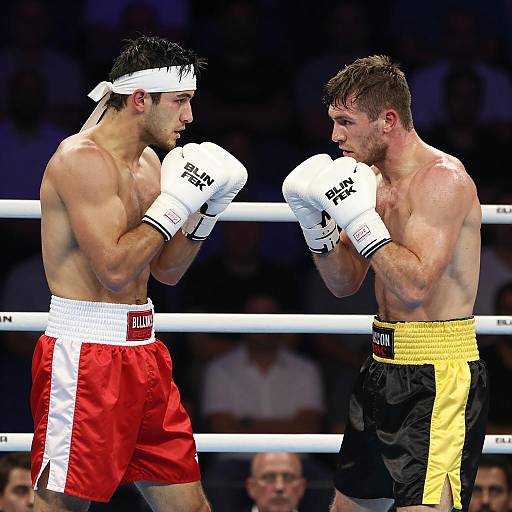 Intense Boxing Match Between Muscular Fighters