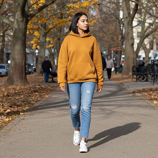 Young Woman Walking in Autumn Park