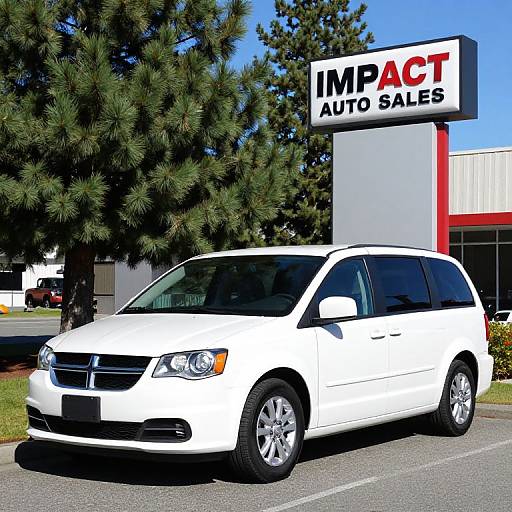 Photograph of a white minivan parked in front of an 