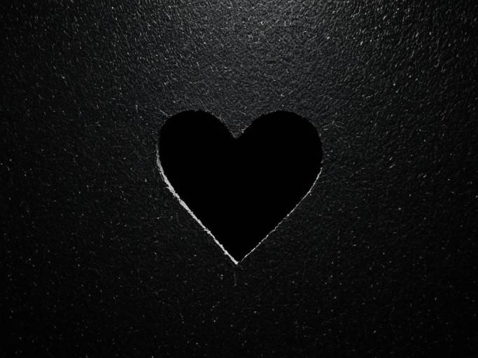 Heart-Shaped Hole in Black Wallpaper