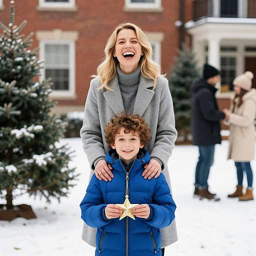 Woman and Boy with Christmas Ornament in Snowy Yard