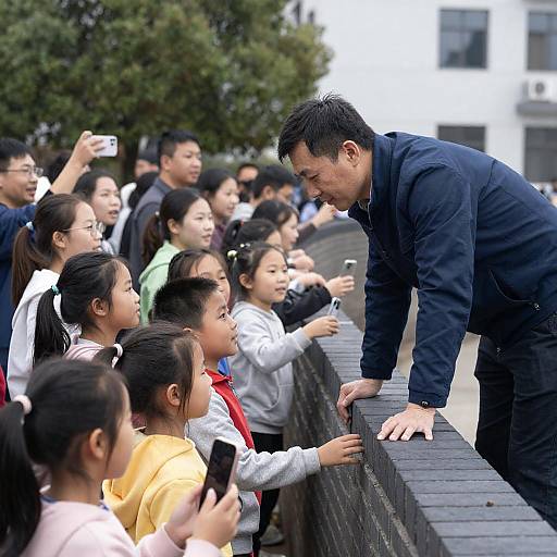 Man Interacting with Crowd Over Brick Wall