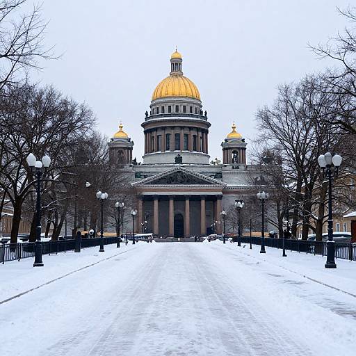 Photograph of a snow-covered plaza leading to a grand, neoclassical building with a golden dome and two smaller golden domes, flanked