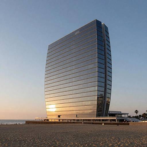 Modern Glass Facade Building on Beach at Sunset