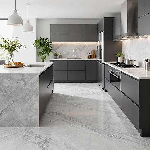 Modern kitchen photograph with dark gray cabinets, white marble countertops and floors, stainless steel appliances, potted plants, and bright overhead lighting.