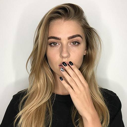 Blonde woman with black geometric nail art