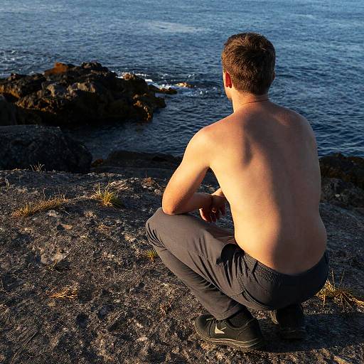 Muscular Man on Rocky Shoreline