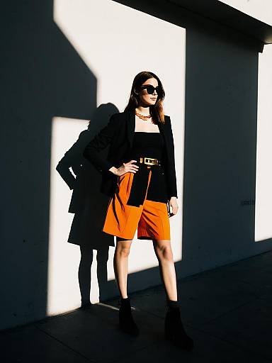 Chic Woman in Black Blazer and Orange Shorts