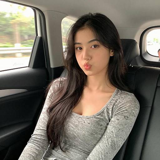 Playful Woman in Car Backseat