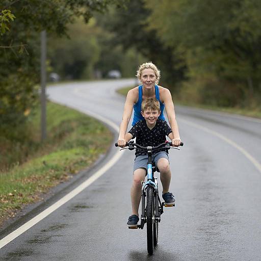 Mother and Son Riding Bicycle on Wet Road