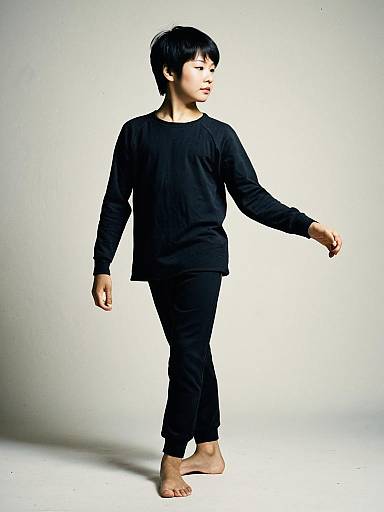 Boy in Black Dance Costume Posing Barefoot