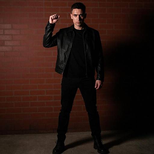 Serious Man in Black Against Red Wall