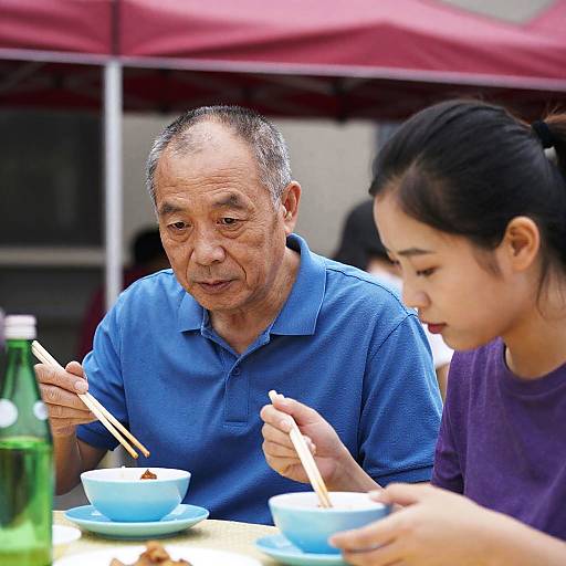 Asian Family Enjoying Meal Outdoors