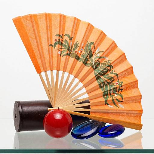 Orange Paper Fan with Decorative Objects