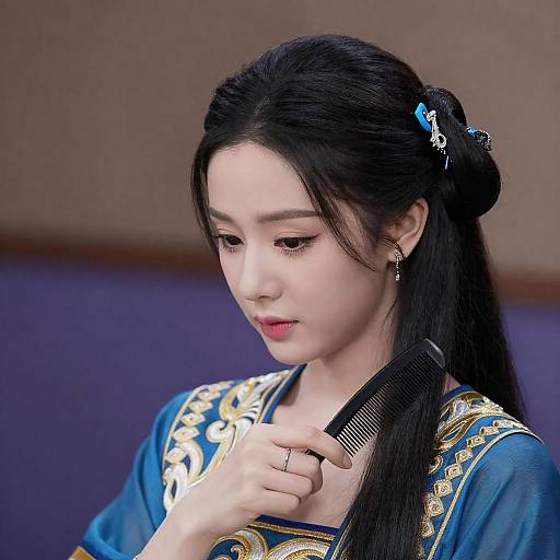 Elegant Asian Woman in Blue and Gold