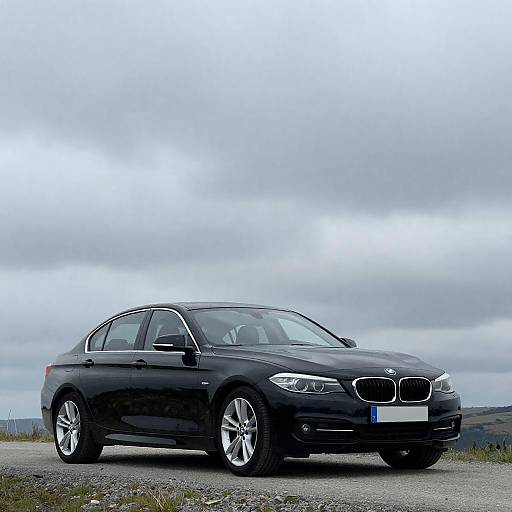 Sleek Black BMW on Gravel Road