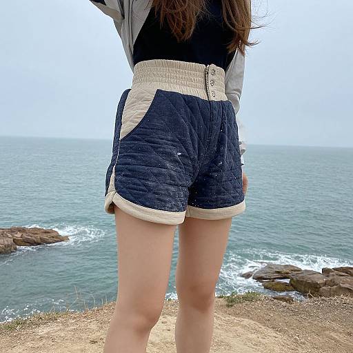 Woman on Coastal Cliff with Quilted Shorts