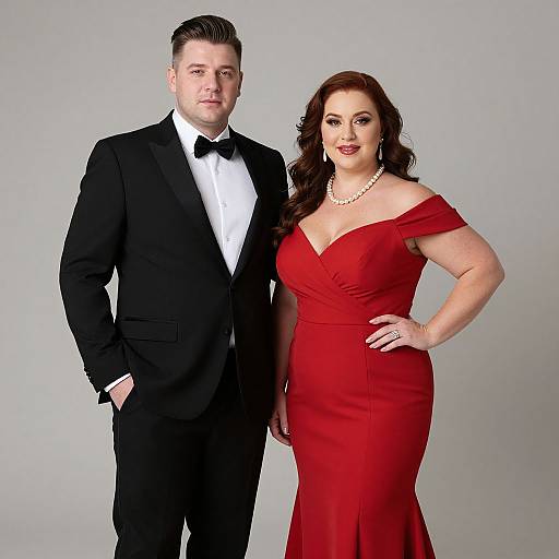 Photograph of a tall, fair-skinned man in a black tuxedo and a curvy, fair-skinned woman in an off-the-