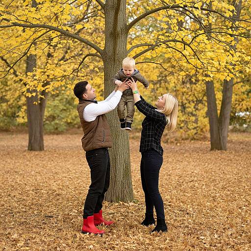 Photograph of a bearded man in a brown vest, black pants, and red boots, holding a blonde baby, with a blonde woman in a