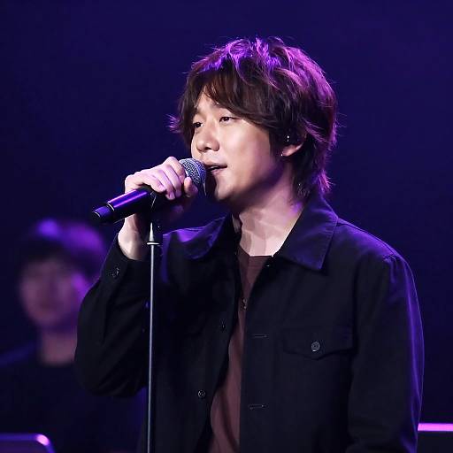 Intense Male Singer Under Purple Lighting