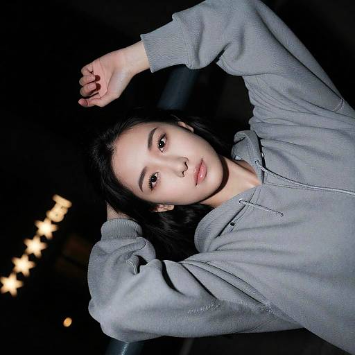 Woman in Gray Hoodie Posing at Night
