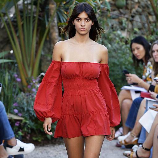 Woman in Red Off-the-Shoulder Dress at Fashion Show