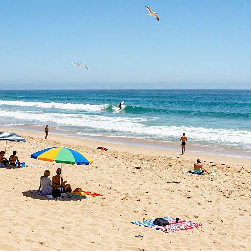 Photograph of sunny beach with colorful umbrella, people lounging, ocean waves, seagulls flying, and a surfer in the distance.