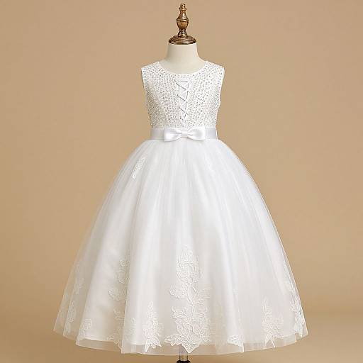 Photograph of a white lace sleeveless dress with a fitted bodice and full tulle skirt, displayed on a mannequin against a beige background