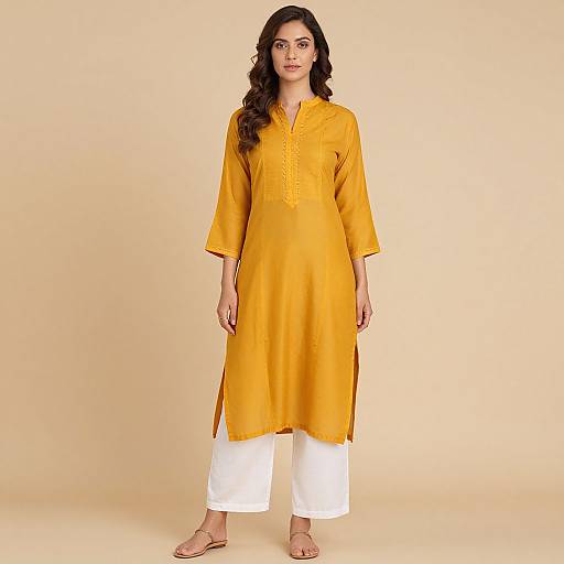 Woman in Mustard Kurta and White Pants