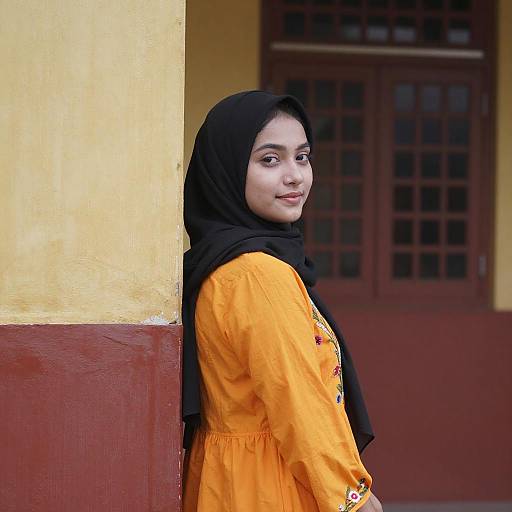 Young Woman in Orange Dress and Hijab