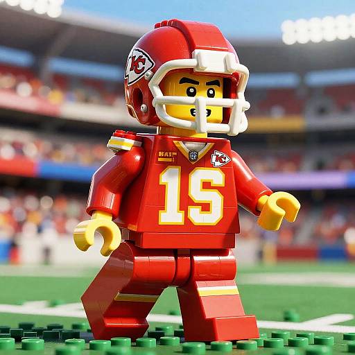 Photograph of a LEGO football player in red uniform with number 15, white helmet, and yellow face, on green brick field, blurred stadium background