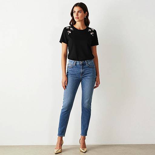 Woman in Floral Embroidered Black T-Shirt and Blue Jeans