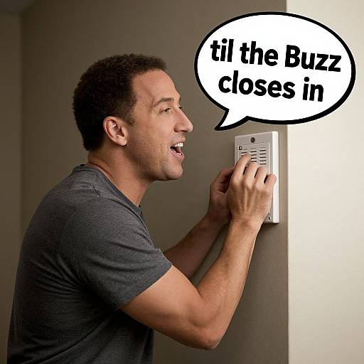 Photograph of a smiling black man with short curly hair, wearing a gray t-shirt, pressing a buzzer with a speech bubble saying 